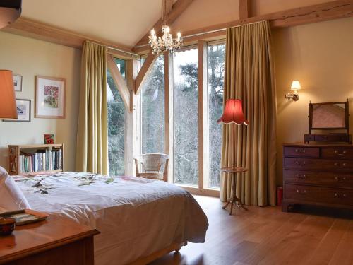 a bedroom with a bed and a large window at Mill Of Burncrook in Glenlivet