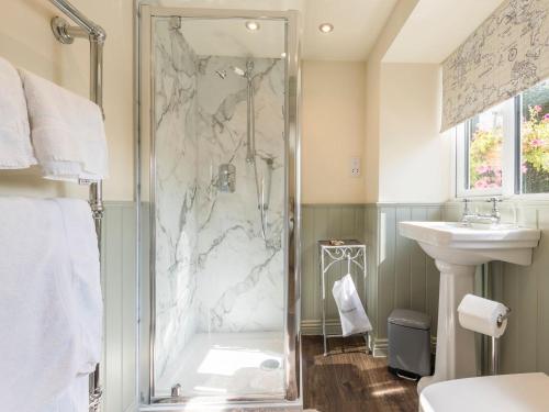 a bathroom with a shower and a sink at Hampsfell Cottage - Uk1518 in Grange Over Sands