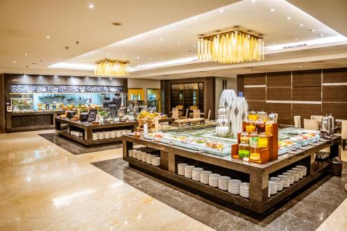 a store with a buffet in a hotel lobby at Grand Tjokro Premiere Bandung in Bandung
