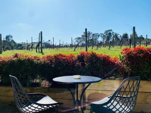 a table and chairs with a view of a field at De'Vine Escape in Dixons Creek