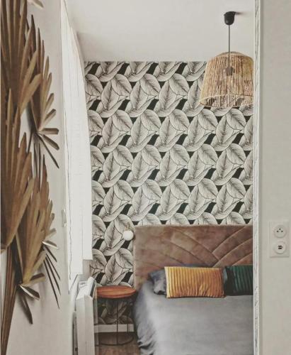 - une chambre avec un mur et un lit dans l'établissement Désirée Logement Cosy et Charmant 1 er étage, à Reims