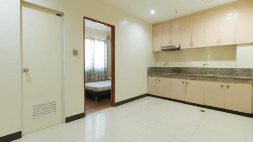 an empty kitchen with a sink and a counter at FMRR Building by RedDoorz in Manila