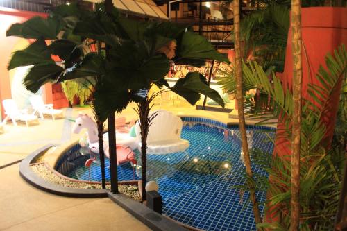 a water park with a pool with a elephant and a unicorn at Kudos Boutique Hotel in Nong Prue