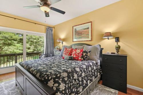 a bedroom with a bed and a window at Gorgeous Cottage with Hot Tub in Boone NC! in Boone