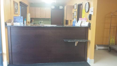 a bar in a kitchen with a counter top at Super 8 by Wyndham Rawlins Wyoming in Rawlins
