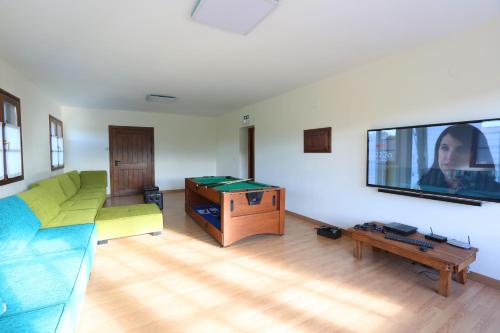 a living room with a couch and a flat screen tv at Ekain-Xokoa in Zugarramurdi