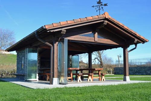 a pavilion with a picnic table in a park at Ekain-Xokoa in Zugarramurdi