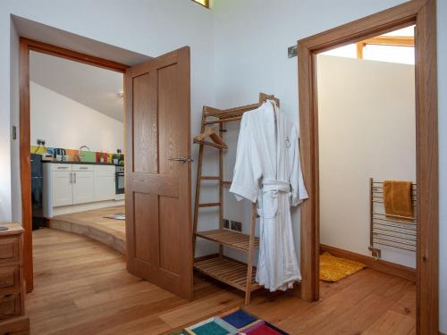 a room with a closet with a towel on a ladder at Old Orchard Barn - The Annexe in Buckland St Mary