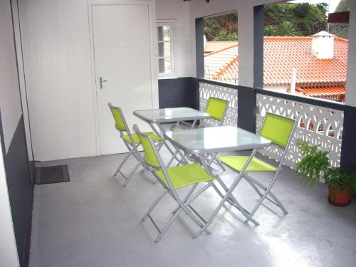 a dining room table with chairs in front of it at Holidays Madeira in São Vicente