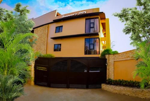 a house with a black gate and a garage at Dianna’s Inn in Coron