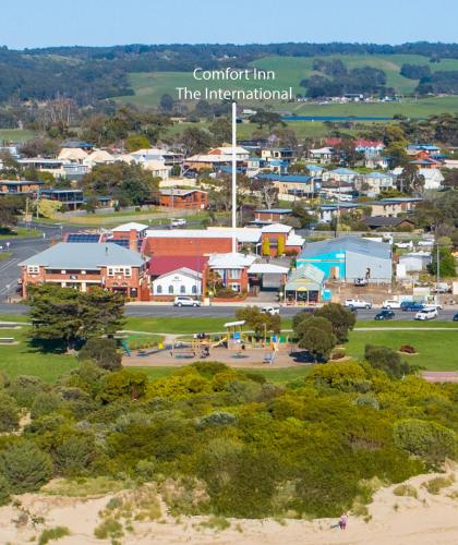 an aerial view of a small town with buildings at The International Motel Apollo Bay in Apollo Bay