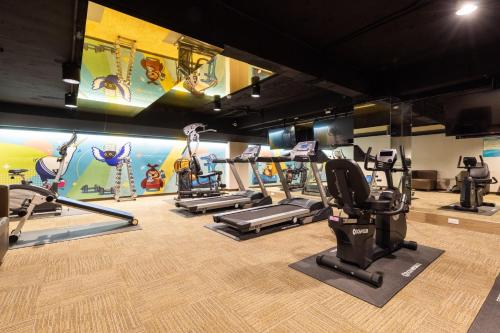 a gym with treadmills and elliptical machines at Taoyuan Yuehua Hotel & Golf Club in Longtan