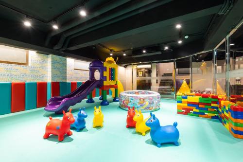 a childrens play area with toys and a playground at Taoyuan Yuehua Hotel & Golf Club in Longtan