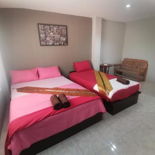 two beds in a room with shoes on them at Haadrin village Fullmoon in Haad Rin