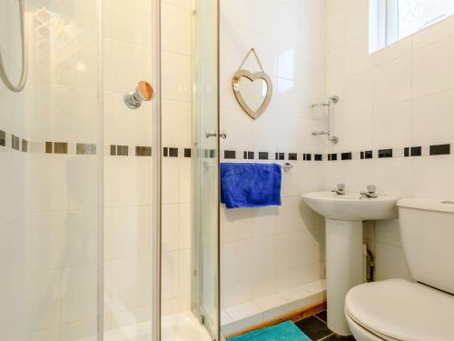 a bathroom with a shower and a toilet and a sink at Hodges - Uk30761 in Gorleston-on-Sea