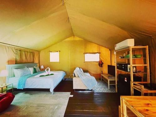 a bedroom with a bed in a tent at Rembulan Escape - Beachfront safari tent in Kampung Penarik