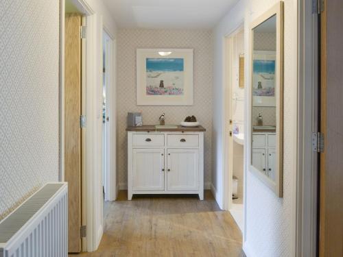 a bathroom with a sink and a white cabinet at Alnwick Old Brewery Apartment in Alnwick