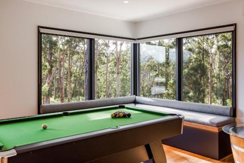 a billiard room with a pool table and windows at Kaya Karri in Margaret River Town