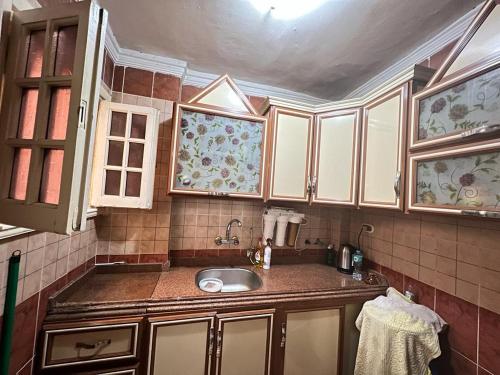 a kitchen with a sink and some cabinets at Downtown Sea View Suites in Alexandria