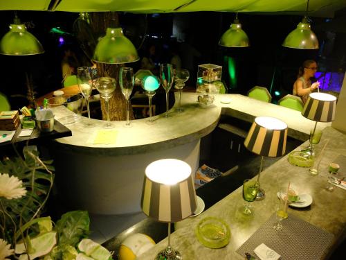 a restaurant with two tables with wine glasses on it at Momento Resort in Pattaya South