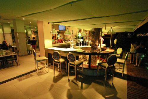 a restaurant with a bar with chairs and a table at Momento Resort in Pattaya South