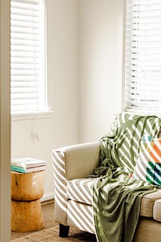 a couch with a blanket on it in a living room at Bay Breeze Boutique Accommodation in Batemans Bay