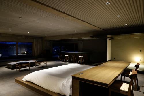 a bedroom with a bed and a table and chairs at Matsumoto Jujo in Matsumoto