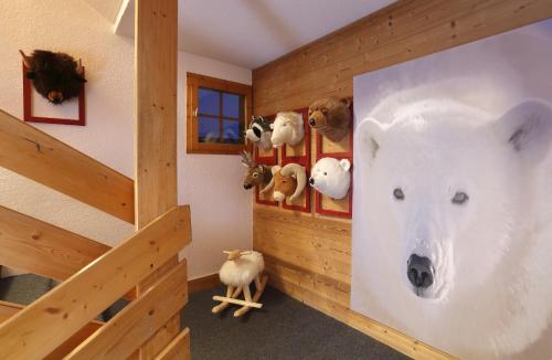 a room with a stuffed polar bear on the wall at Hôtel du Bourg in Valmorel