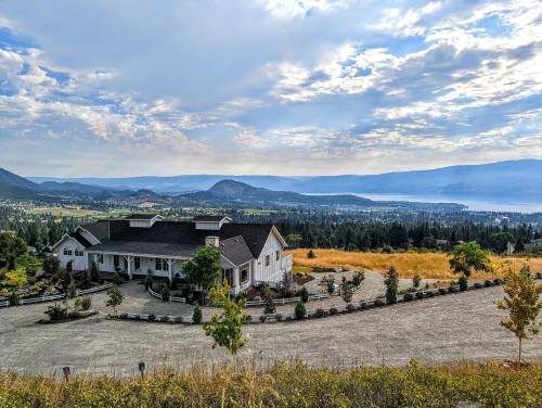 an estate in the mountains with a large house at Autumn Lane, modern Farmhouse Style B&B with Stunning Lakeviews in West Kelowna