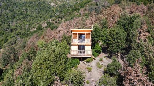 a tree house on the side of a mountain at LES CABANES DE LUTINA in Poggio-Marinaccio