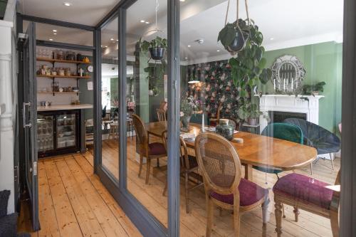a dining room with a table and a christmas tree at House Arundel in Arundel