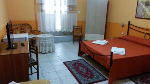 a bedroom with a bed and a table and chairs at Hotel Gorizia in Catania