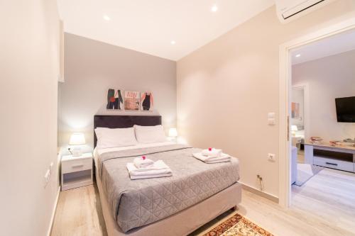a bedroom with a bed with two towels on it at Seawind Gouvia in Gouvia
