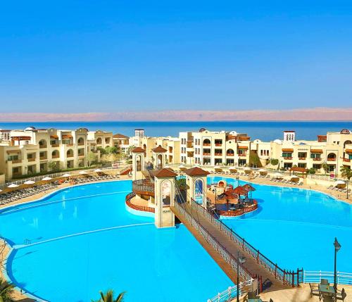 a view of a large swimming pool in a resort at Crowne Plaza Jordan Dead Sea Resort & Spa, an IHG Hotel in Sowayma