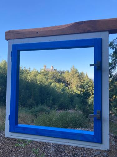 a mirror with a view of a forest at Penzion Na Habeši in Kašperské Hory