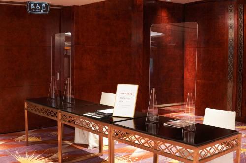 a table with wine glasses on it in a room at Grand Hyatt Hong Kong in Hong Kong