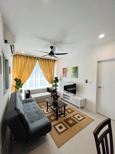 a living room with a couch and a table at Aina Staycation, Metrocity in Kuching