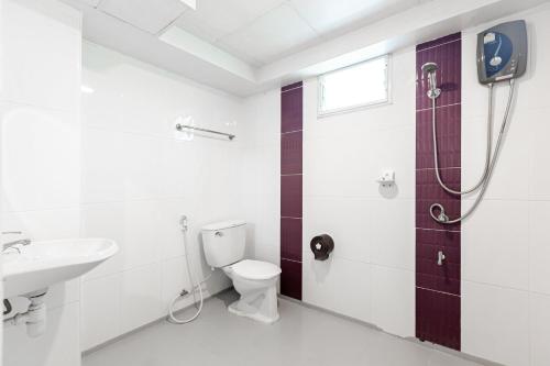 a bathroom with a toilet and a sink and a shower at Latin Garden Hotel in Bangkok