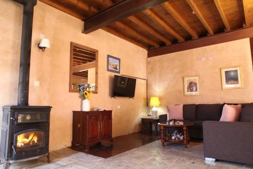 a living room with a couch and a fireplace at Agrovino Lofou in Lofou
