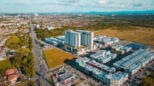 an aerial view of a city with buildings at Aina Staycation, Metrocity in Kuching