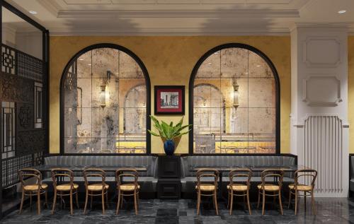 a waiting room with a row of chairs and a table at Adora Art Hotel in Ho Chi Minh City