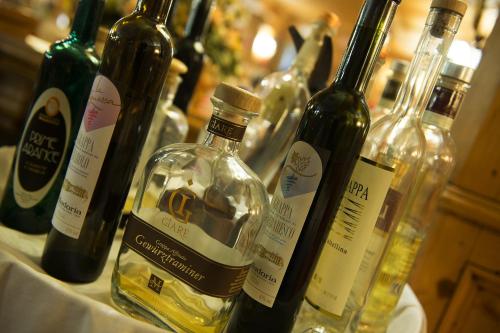 a group of wine bottles sitting on a table at Hotel Valtellina in Livigno