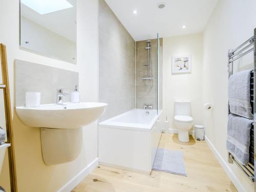 a white bathroom with a sink and a toilet at Owl Barn -- Uk30757 in Bream