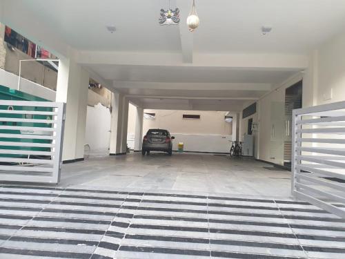 an empty garage with a car parked in it at Hotel Sri Ram Grand in Vijayawāda