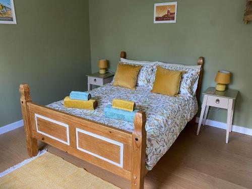 a bedroom with a bed with two tables and two lamps at Beekeepers Cabin in Reepham