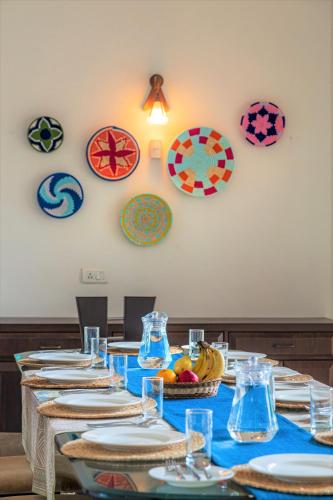 a long table with plates and bowls of food on it at SaffronStays Ananya, Karjat in Karjat