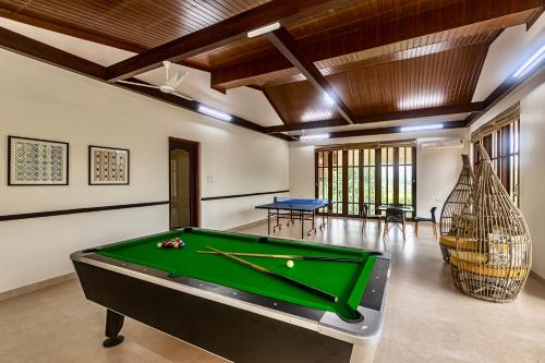 a pool table in a living room with a pool table at SaffronStays Ananya, Karjat in Karjat