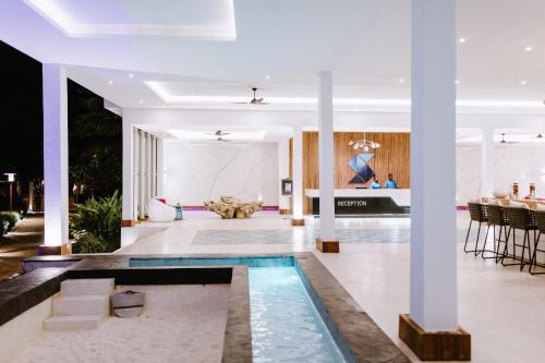 a living room with a pool in the middle of the room at Safira Blu Luxury Resort & Villas in Nungwi