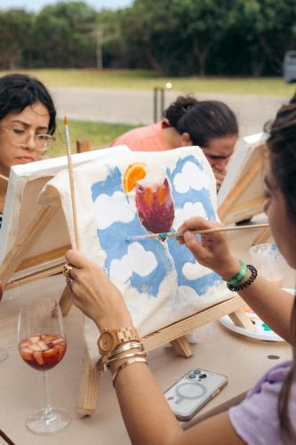 a group of people sitting at a table painting at Safira Blu Luxury Resort & Villas in Nungwi