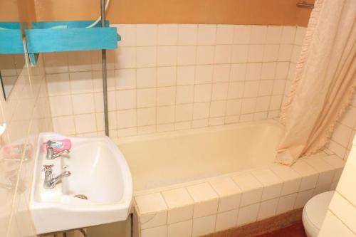a bathroom with a sink and a bath tub at Nyahururu Highlands Heaven -BnB in Nyahururu